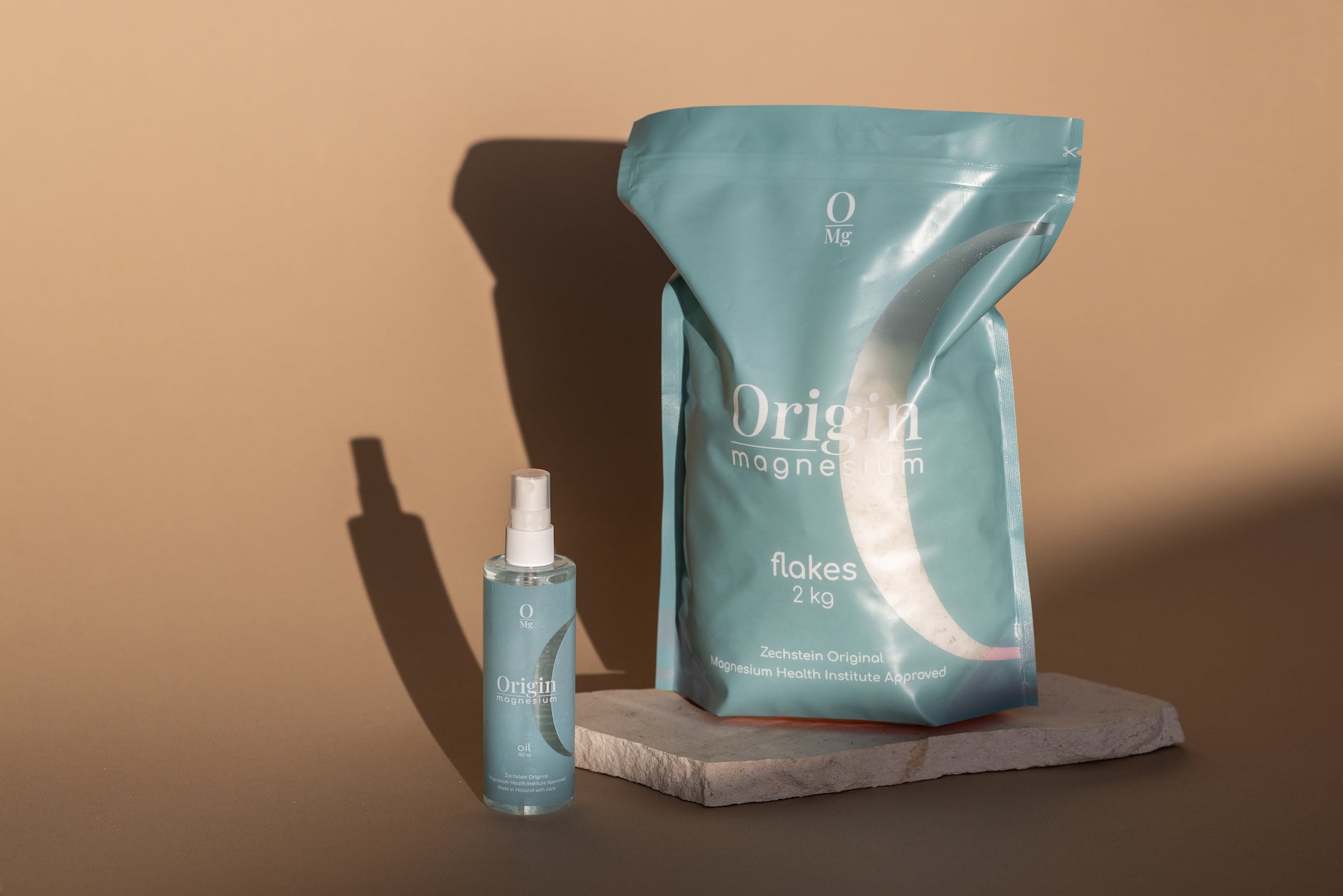 magnesium flakes and oil in the blue Origin OMG packaging on a brown background